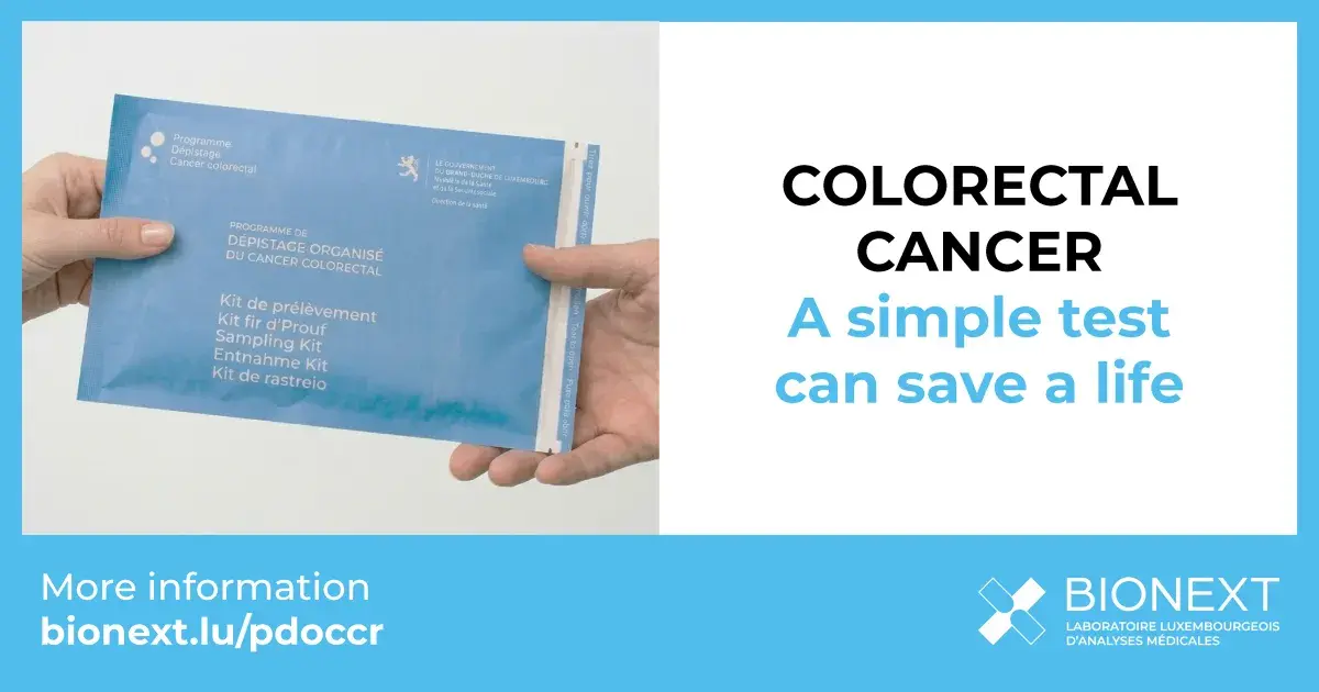 Colorectal cancer screening kit from the Luxembourg national programme held in hand.