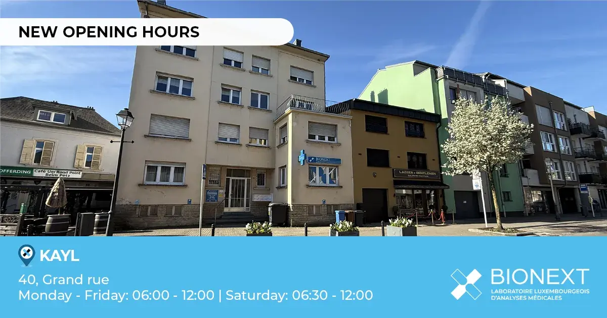 Front view of a BIONEXT building located in Kayl, with the heading ‘New opening hours’. The image shows the address ‘40, Grand rue’ and opening hours: Monday to Friday from 06:00 to 12:00, and Saturday from 06:30 to 12:00.